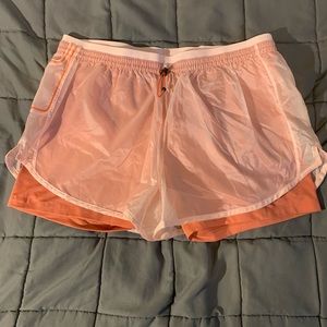 Nike peach coloured running shorts